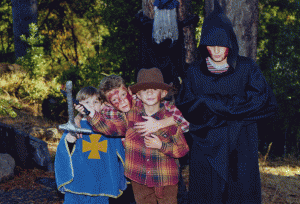 Four of the boys in costume for Halloween 2002. My favorite decoration of the season was the witch who every year splaltted into the tree behind them. You can't see her broomstick in this photo, but it stuck out behind her and seemed to be impaled in the tree!