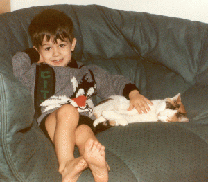 This one taken around the time that Tom arrived, when Nick was a little over three, with Banane, our little tortoiseshell cat. Nick named her Banane because when we were given her and asked him to name her, "banane" was the only word that he spoke. Guess what he ate an awful lot of!!