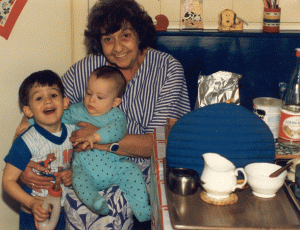 Paris had the advantage of being relatively close to my mum, Nick and Tom's grandma, who lived just west of London. Here she is in early 1990, in the kitchen of her home in Marlow, with Nick aged three and a half with a bottle in his hand and Tom just a baby. Under the tea cozy there was certainly a pot of tea. Grandma loved her cup of tea.