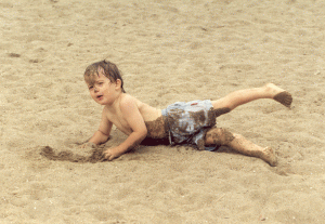 Tom likes sand. Here he is rolling around on the beach during the summer of 1992.