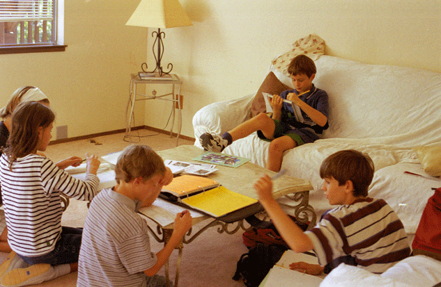 Proof that sometimes homework actually does get done! September 1999 at home, with Amélie (hidden by Daphné) in charge. This was taken before the furniture arrived, as you can tell from the bare walls.