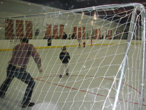 Alex is taking a shot on the hard indoor field in Scotts Valley, since converted into a library, with his dad playing the role of goalie, with mixed results!
