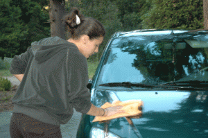 Needless to say, Daphné was delighted with the car that arrived for her unannounced in the High School parking lot one day after school. Here she is polishing it.