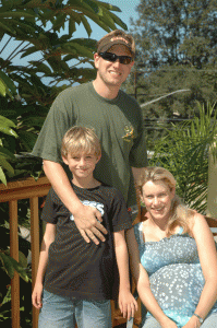 Antony and Courtney on their roof in 2005 with Charlie. You can't see it in this photo, but the Pacific is spread out behind them down the hill.