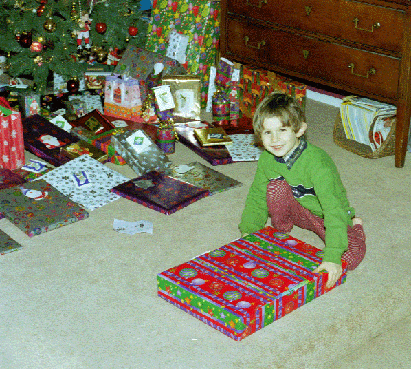 Alex with one of his Christmas presents in 2002. He had just selected it from under the tree. Whoever was there with us on Christmas morning picked out his or her presents in order of increasing age, meaning that Alex picked first. Which suited him just fine!