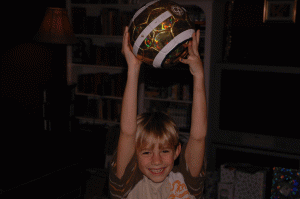 Christmas 2004 saw toe of our family preoccupations linked. The letters to Santa featured several requests for soccer things. Here is Charlie filled with glee and holding his golden ball! 