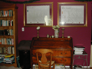 My desk against the living room wall, with two of dad's deeds framed above it.