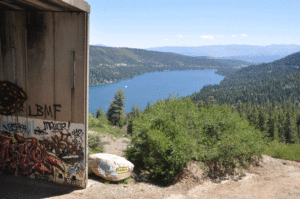 The beautiful view coming out of the disused Donner Pass tunnels, with Donner lake in the background and a yellow submarine on a rock in the foreground. 