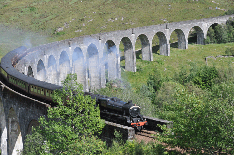 Where I was heading for on this holiday: Glenfinnan Viaduct, with the Hogwarts Express at speed. The train is called the Jacobite in real life, after the rebellion remembered a half mile away. That's right, you can't find platform 9-1/2 at Kings Cross Station in London, but you can find this feature of the Harry Potter films with a real steam train on it! Tom and I walked the trail to get in position for this photo.